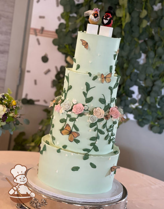 4-Tier mint green cake with hand piped green vines and pastel-colored sugar flowers and monarch butterflies.