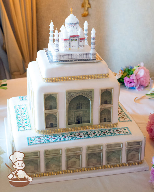 Large Taj Mahal Indian Themed Cake. Cake is wrapped in white fondant with printed images and gold rhinestone band.