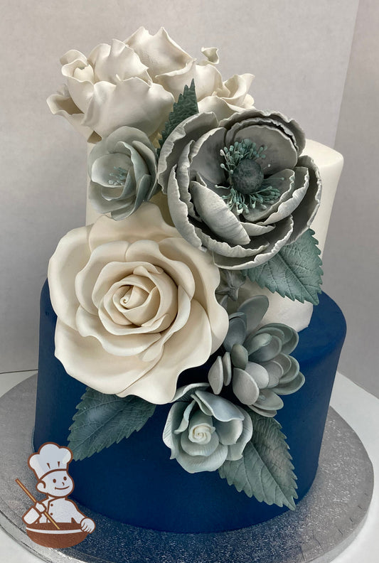2 tier buttercream wedding cake with navy blue bottom and white top tier and decorated with pearlescent silver & white sugar flowers.