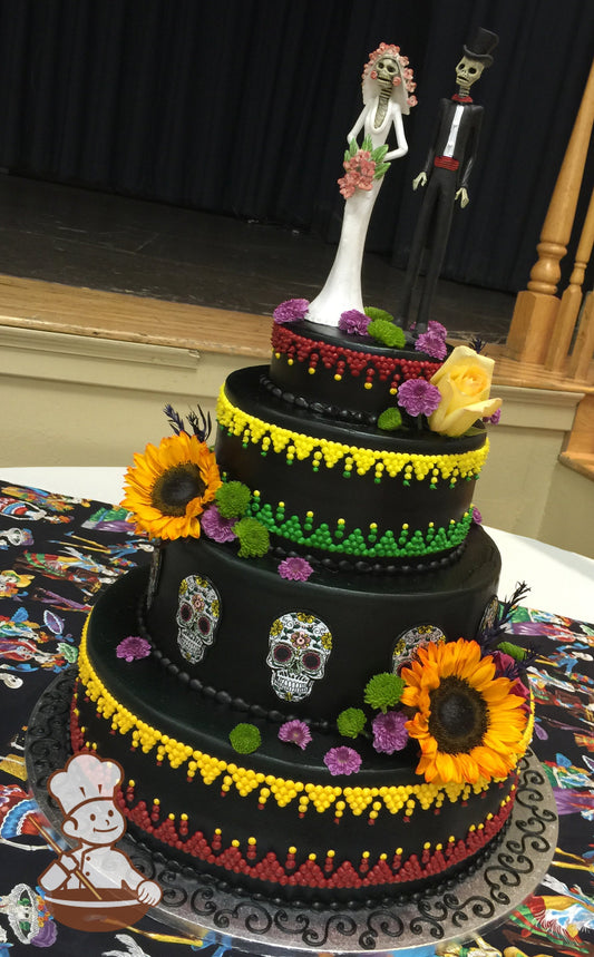 4-tier Day of the Dead cake with brigh color patterns, calavera skulls, and colorful flowers.