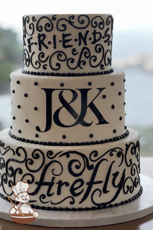 3-tier white cake with black scrolls and piping around custom text. Top tier has "F-r-i-e-n-d-s", Middle has initials and bottom has "firefly".