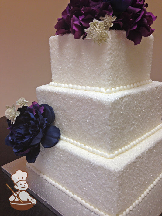 3 Tier Square Buttercream cake covered with sugar crystals and finished with fresh flowers.