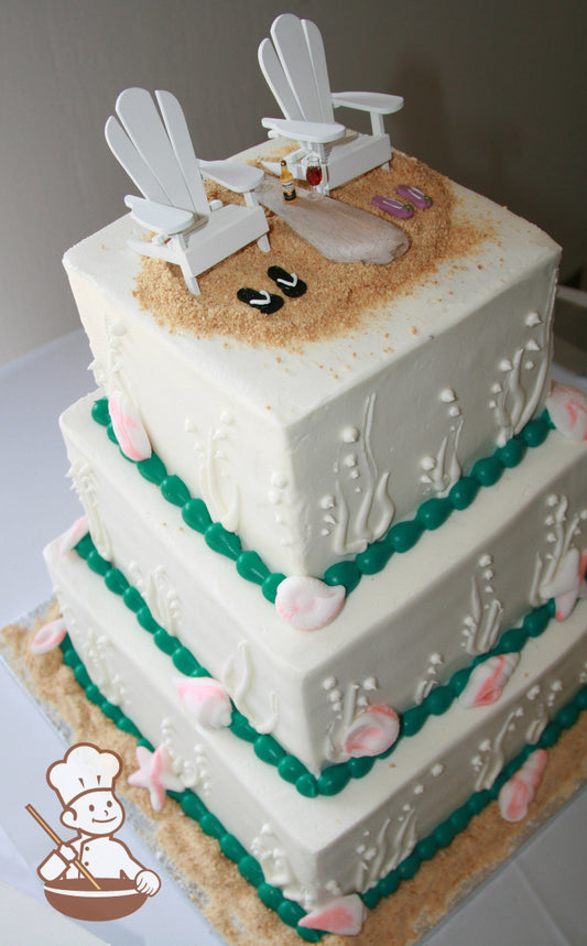 3-tier cake with white icing and decorated with white buttercream piped corals and marbleized seashells with sugar "sand" and beaded trims.