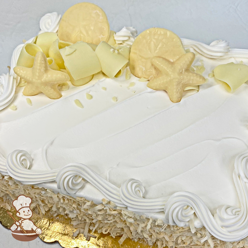 Sheet cake with toasted coconut shavings, white chocolate curls and seashells.