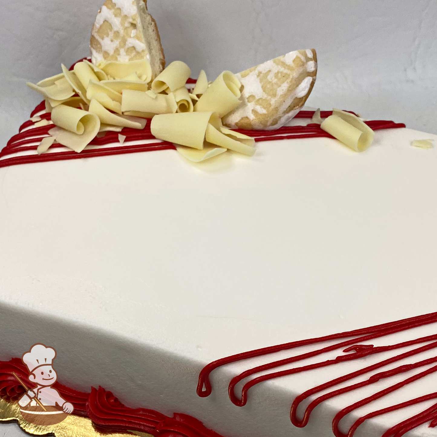 Sheet cake with butter shortbread cookies, whipped cream and white chocolate curls.