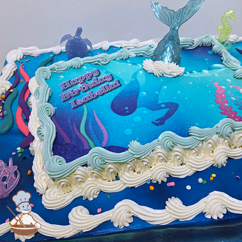 Birthday sheet cake with photo layer of mermaid and toy tail and underwater creatures.