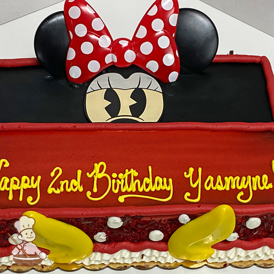 Birthday sheet cake with Disney Minnie Mouse toy.