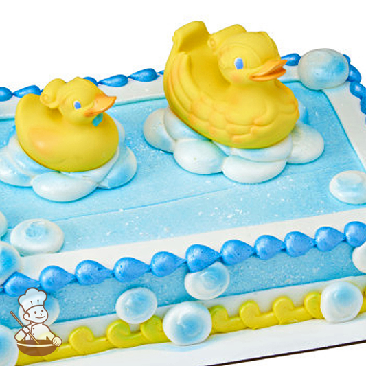 Baby shower sheet cake with rubber duck toy set and buttercream bubbles.