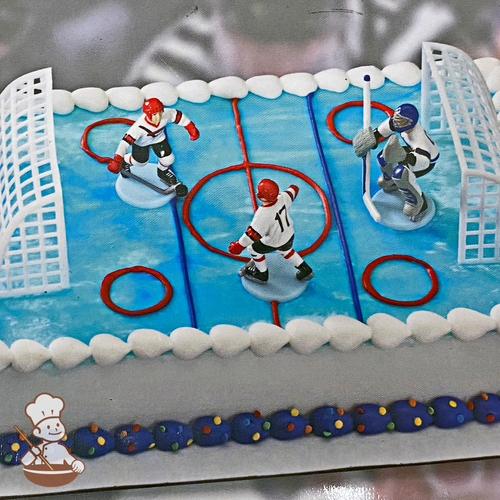 Birthday sheet cake with hockey player toy set and buttercream ice rink.
